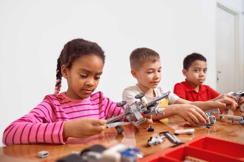 Kids using building kit to create toys